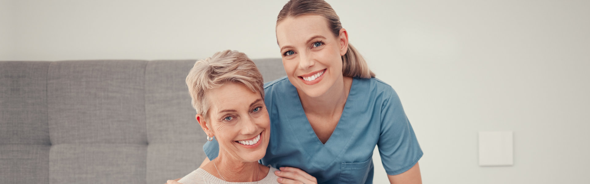 caregiver and elderly woman smiling